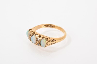 Lot 531 - Opal and diamond ring with three opal cabochons interspaced by four old cut diamonds in carved gold claw setting on 18ct gold shank, (Birmingham 1918)