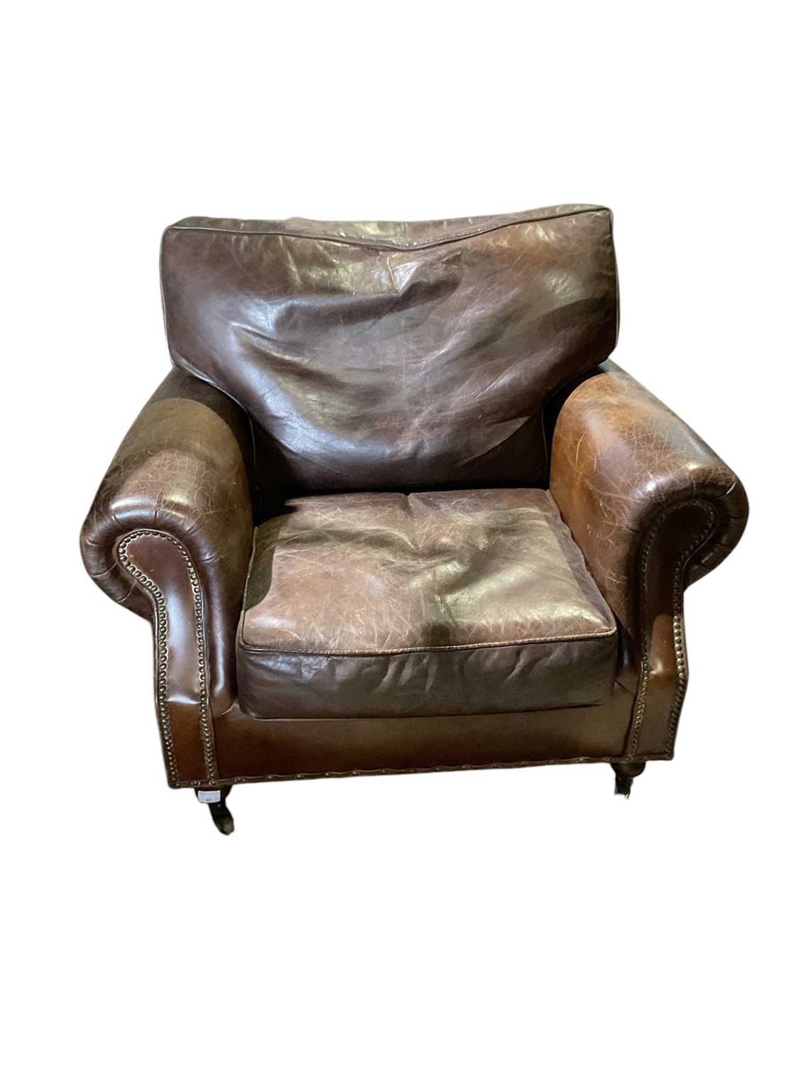 Lot 81 - Brown leather armchair with studded decoration