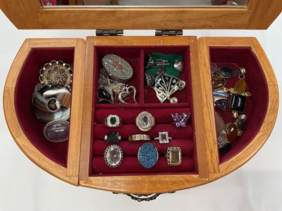 Lot 111 - Wooden jewellery box containing silver and white metal jewellery including gem set pendants and rings, earrings, green hard stone bead necklaces etc