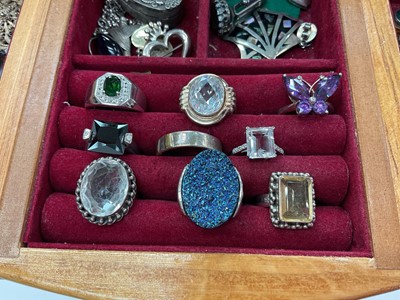 Lot 111 - Wooden jewellery box containing silver and white metal jewellery including gem set pendants and rings, earrings, green hard stone bead necklaces etc