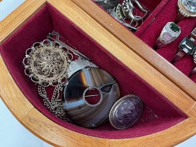 Lot 111 - Wooden jewellery box containing silver and white metal jewellery including gem set pendants and rings, earrings, green hard stone bead necklaces etc
