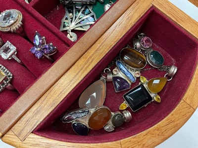 Lot 111 - Wooden jewellery box containing silver and white metal jewellery including gem set pendants and rings, earrings, green hard stone bead necklaces etc