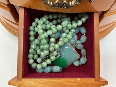 Lot 111 - Wooden jewellery box containing silver and white metal jewellery including gem set pendants and rings, earrings, green hard stone bead necklaces etc