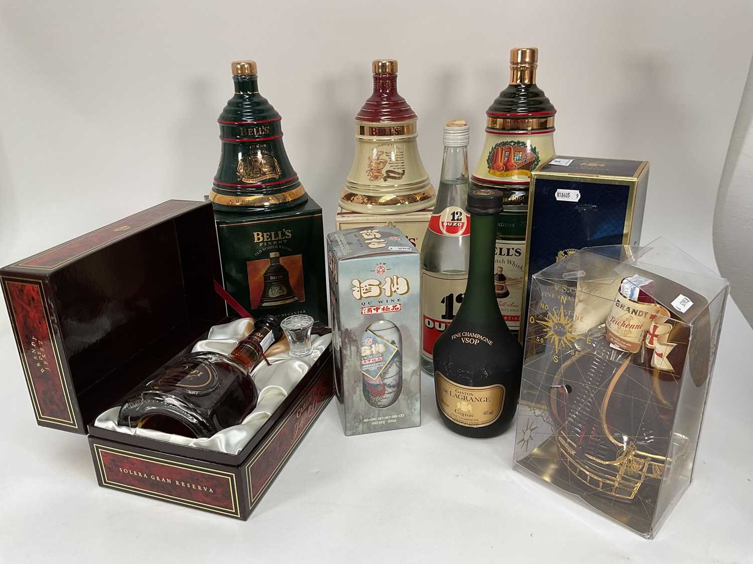 Lot 28 - Eight bottles including, three Bell's Christmas decanters, Carlos I Imperial, V.S.O.P Gaston de Lagrange Cognac, Ouzo and other bottles (8)