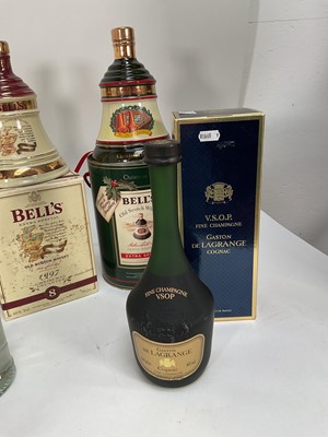 Lot 28 - Eight bottles including, three Bell's Christmas decanters, Carlos I Imperial, V.S.O.P Gaston de Lagrange Cognac, Ouzo and other bottles (8)