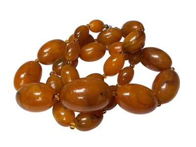Lot 171 - Vintage simulated amber bead necklace, 61cm long and a simulated cherry amber bead necklace, 54cm long (2)