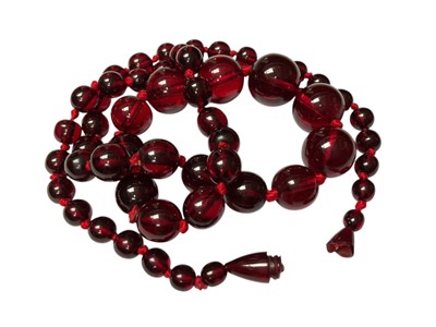 Lot 171 - Vintage simulated amber bead necklace, 61cm long and a simulated cherry amber bead necklace, 54cm long (2)