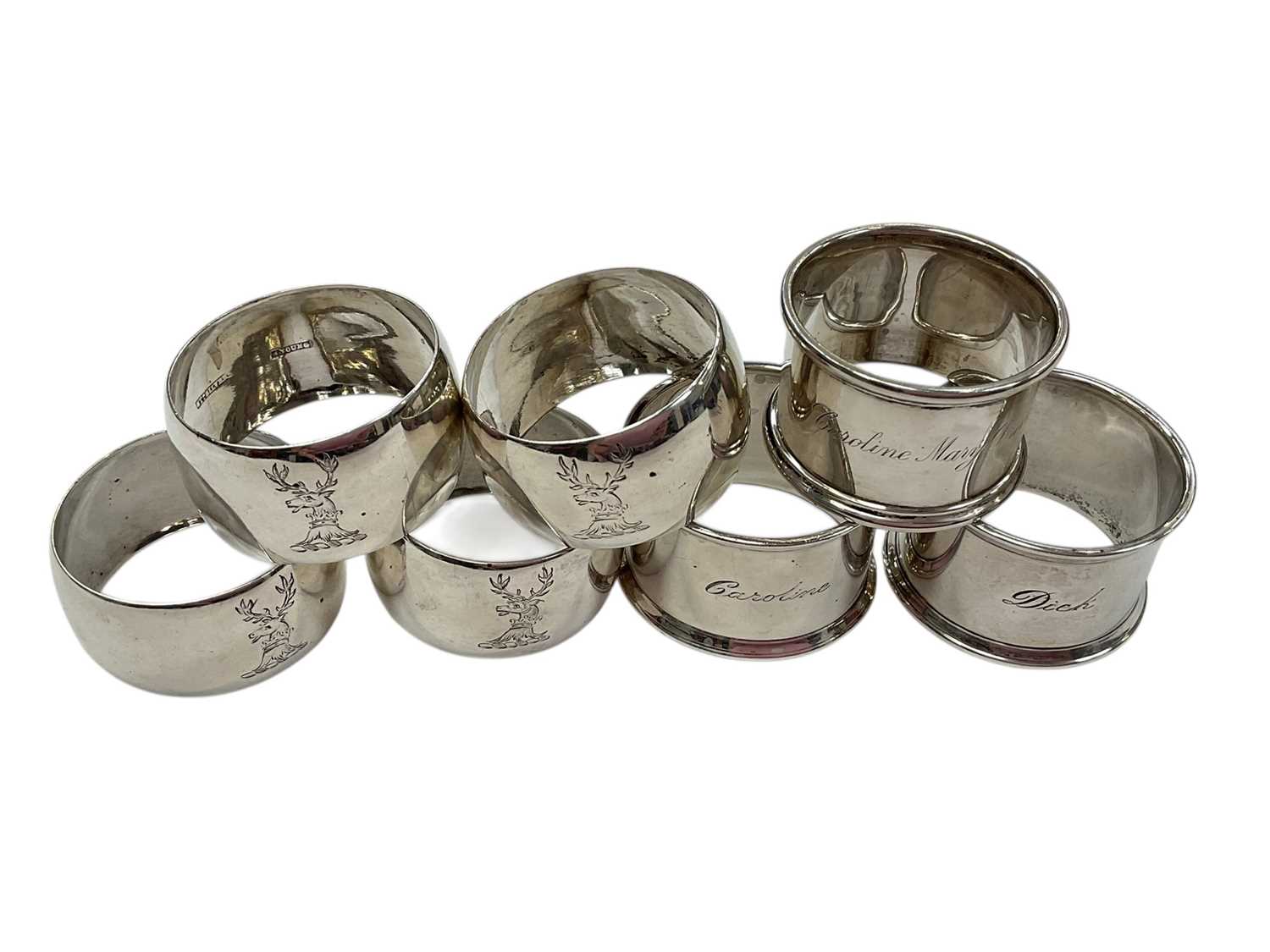 Lot 140 - Group of seven silver napkin rings, including one engraved 'Dick', (various dates and makers), all at approximately 5ozs (7).