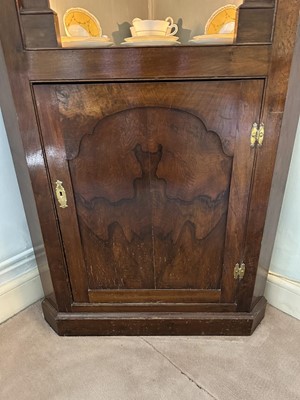 Lot 1255 - Antique mahogany two-height corner cupboard, painted interior with three shaped shelves above a single cupboard below, 197cm high