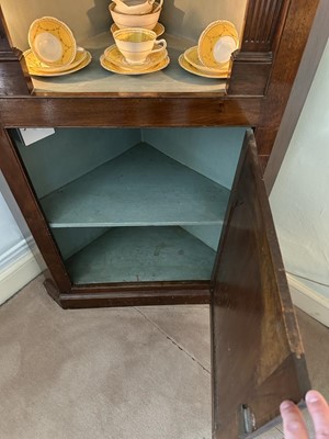 Lot 1255 - Antique mahogany two-height corner cupboard, painted interior with three shaped shelves above a single cupboard below, 197cm high