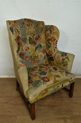 Lot 1300 - George III style wing armchair with elaborate folk art needlework tapestry upholstery.
