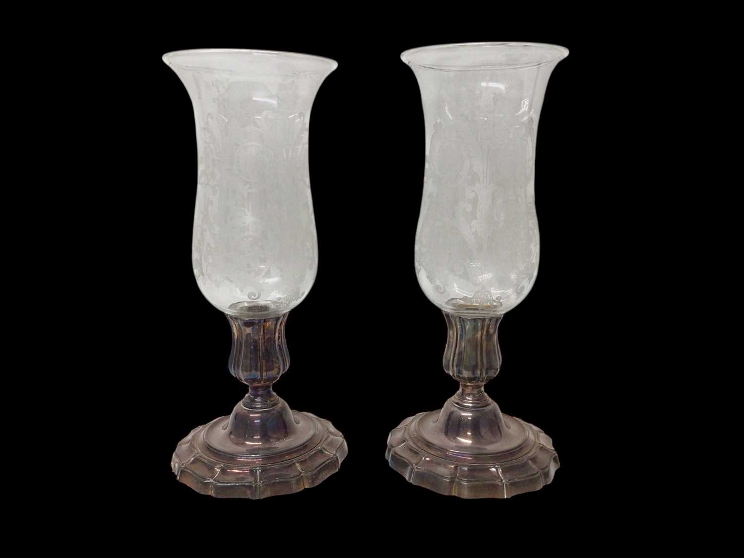Lot 1150 - Two Baccarat etched glass hurricane lamps on plated stands, 40cm high and 39.5cm high