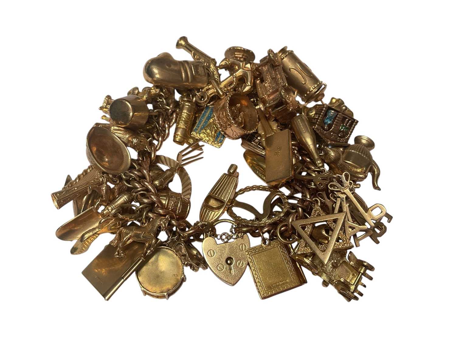 Lot 18 - 9ct gold curb link charm bracelet with padlock clasp extensive collection of 9ct gold and yellow metal novelty charms