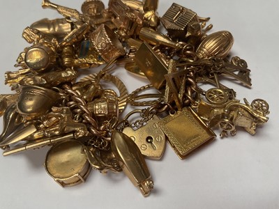 Lot 18 - 9ct gold curb link charm bracelet with padlock clasp extensive collection of 9ct gold and yellow metal novelty charms