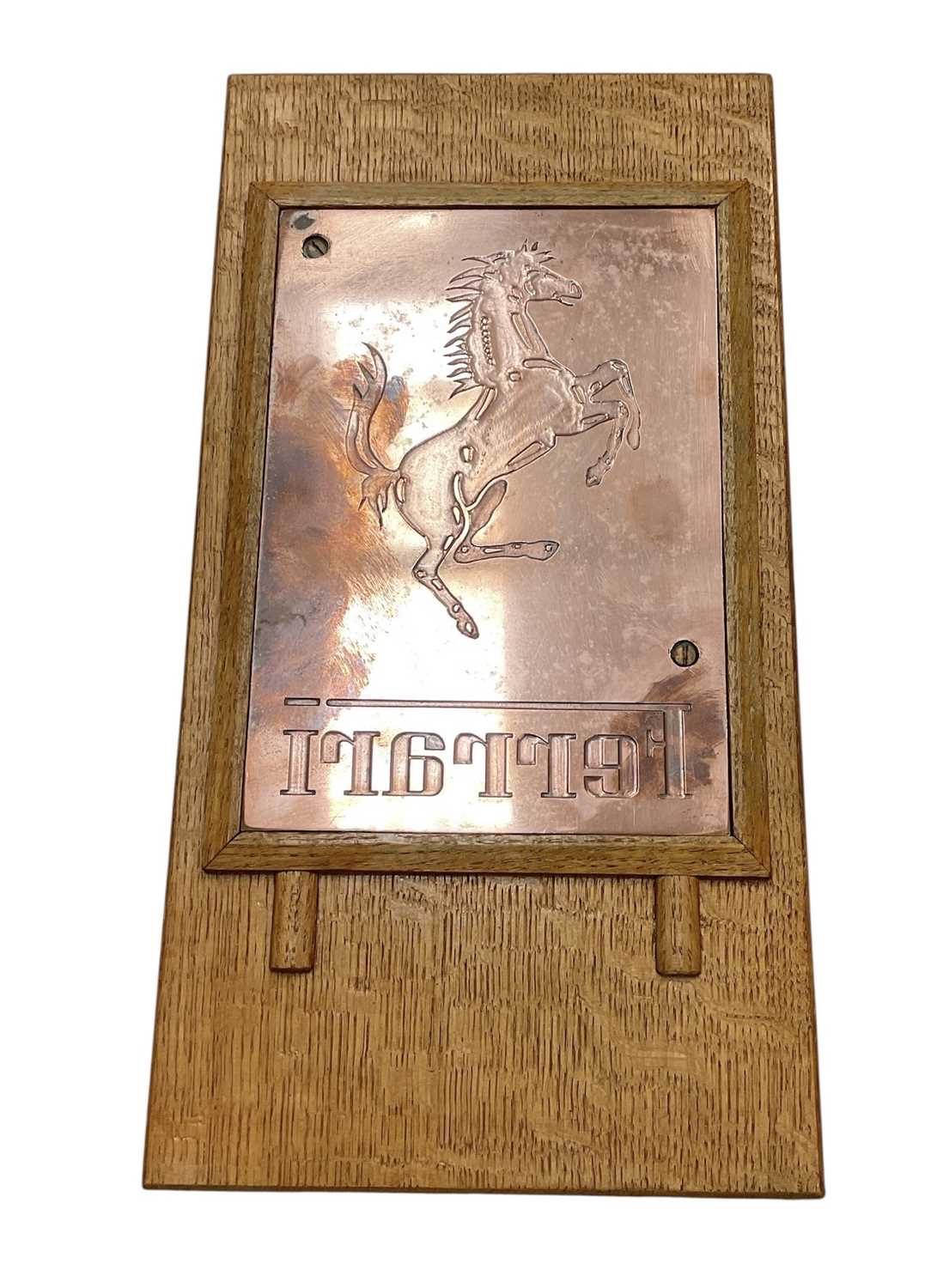 Lot 8 - Ferrari interest- polished copper printing plate, used to produce the embossed cover of the official 1988 Ferrari UK calendar, mounted in an oak frame, the printing plate 25.5 x 17.5cm, 45 x 23c...