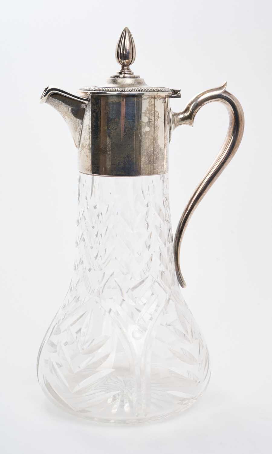Lot 452 - Large Elizabeth II silver mounted cut glass claret jug, with hinged cover and scroll handle, (London 1965), maker Asprey & Co Ltd. 32cm overall height.