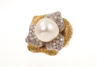 Lot Cultured pearl and diamond cocktail ring, the stylised flower design with a 13-13.5mm cultured pearl, pavé set diamonds and textured gold leaves, ring size approximately N-O.