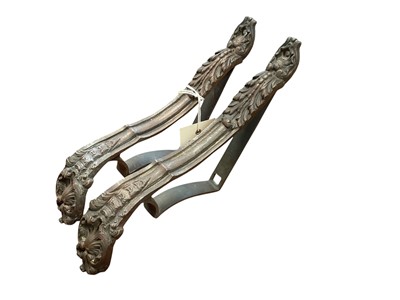 Lot 5001 - A pair of rococo-style bronze curtain tiebacks, late 19th century, each cast with acanthus leaves and shells, signed 'P D' to the reverse, 5cm wide, 15cm deep, 27cm high (2) Provenanc...
