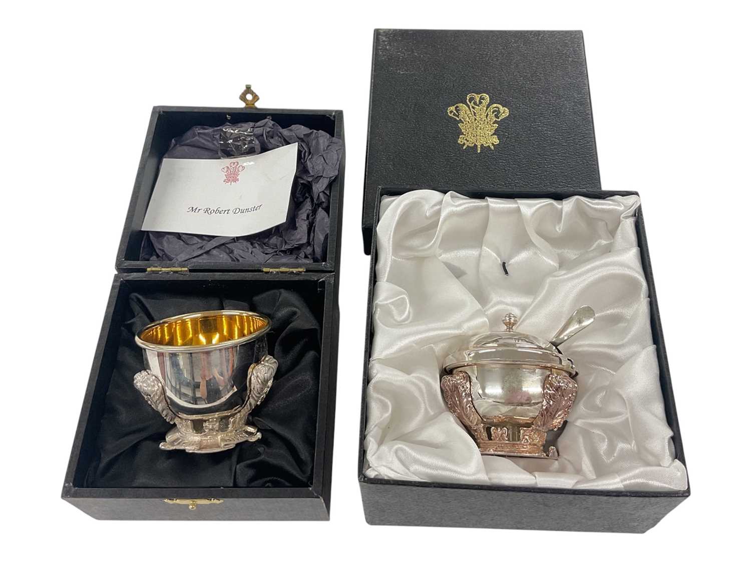 Lot 63 - H.R.H. Prince Charles, Prince of Wales, two Royal Christmas gifts comprising silver plated salt and mustard pot with cover and spoon with cast Prince of Wales feather crest decoration to bases in...