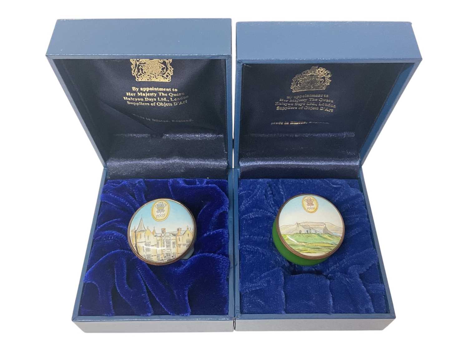Lot 68 - H.R.H. Prince Charles, Prince of Wales, two Royal presentation Halcyon Days enamel boxes decorated with castles and landscapes