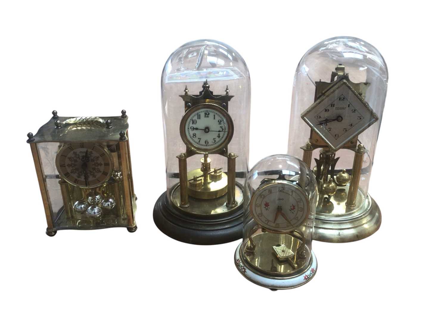 Lot 5000 - Four anniversary pendulum clocks to include three dome cased clocks to include Violeta, Schats and one other together with a quartz Haller mantel clock