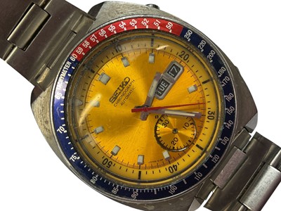 Lot 64 - 1970s Seiko Chronograph Automatic wristwatch, with circular yellow dial, day and date aperture, subsidiary seconds, red and blue 'Pepsi' bezel measuring 38mm diameter, in a stainless steel case...