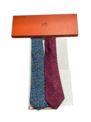 Lot 2506 - Two Hermès silk ties, blue and yellow ribbons 7170 FA red and blue French flag Bastille Day 7171FA, in one box