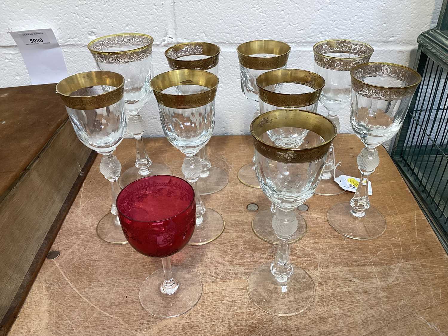 Lot 5032 - Nine Bohemian gilt and cut wine glasses with baluster stems, and a cranberry glass
