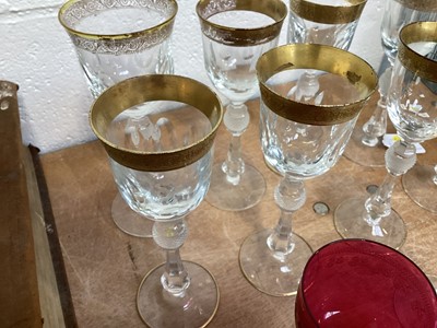 Lot 5032 - Nine Bohemian gilt and cut wine glasses with baluster stems, and a cranberry glass
