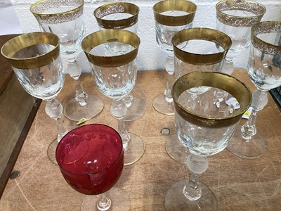 Lot 5032 - Nine Bohemian gilt and cut wine glasses with baluster stems, and a cranberry glass