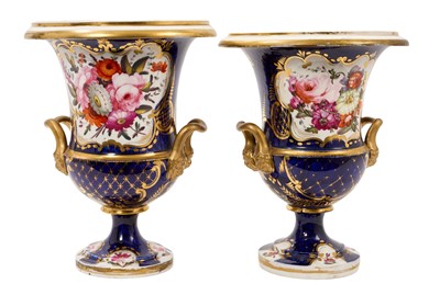 Lot Large pair of early 19th century English porcelain campana shape urns / vases, possibly Coalport, polychrome painted with flowers on a gilt and cobalt blue ground, 23.25cm high