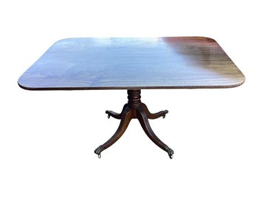 Lot 5348 - Georgian mahogany tilt top dining table with brass lion feet casters, 138cm wide x 100cm deep x 76cm tall