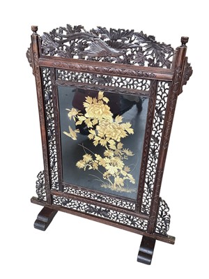 Lot 5337 - Japanese carved wood firescreen with silk embroidered panel, 102cm high, and another screen with printed decoration (2)