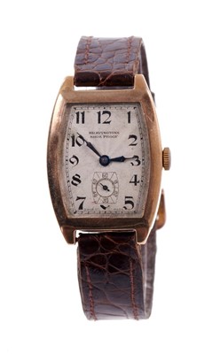 Lot 5208 - 1930s Gentlemen's 9ct gold Bravingtons wristwatch with tonneau shape dial and case on brown leather strap with gold buckle. Case approximately 26mm x 38mm including lugs.
