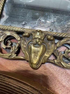 Lot 5090 - Victorian brass easel mirror with mask and scrolling foliage, engraved with a crown and initials, 45cm x 27cm, together with an oval gilt wall mirror (2)