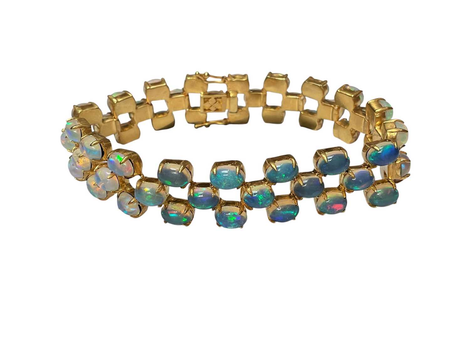 Lot 7 - Contemporary opal bracelet with 54 oval opal cabochons in a three row brick link design in silver gilt setting, 18cm long