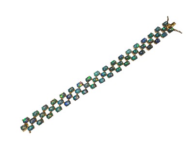 Lot 7 - Contemporary opal bracelet with 54 oval opal cabochons in a three row brick link design in silver gilt setting, 18cm long
