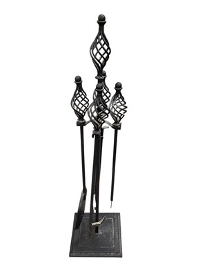Lot 5332 - Cast iron fire tools on stand measuring 90cm tall