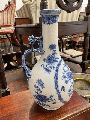 Lot 5169 - 18th/19th century Chinese blue and white porcelain ewer, painted with flowers, with dragon-form handle, 26.5cm high