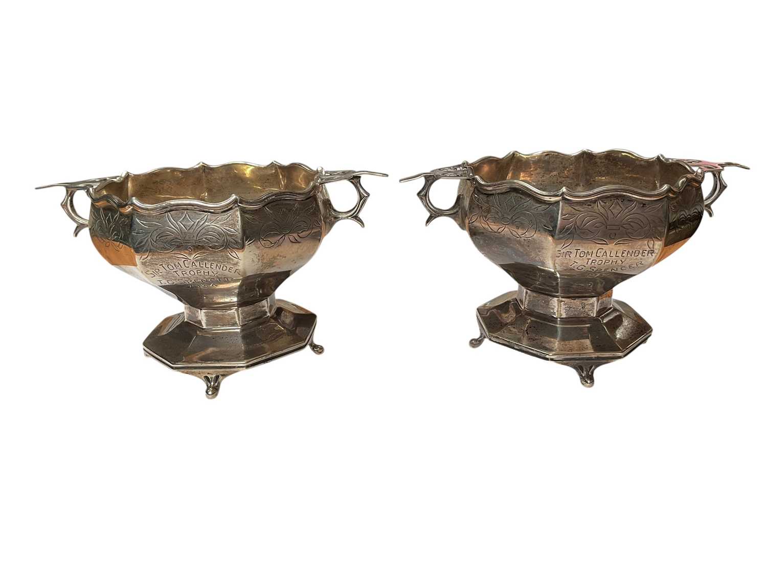 Lot 36 - Pair of 1920s silver two handled pedestal bowls with engraved decoration and presentation inscriptions (London 1928), 7cm high x 13.5cm overall width