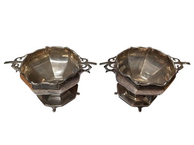Lot 36 - Pair of 1920s silver two handled pedestal bowls with engraved decoration and presentation inscriptions (London 1928), 7cm high x 13.5cm overall width