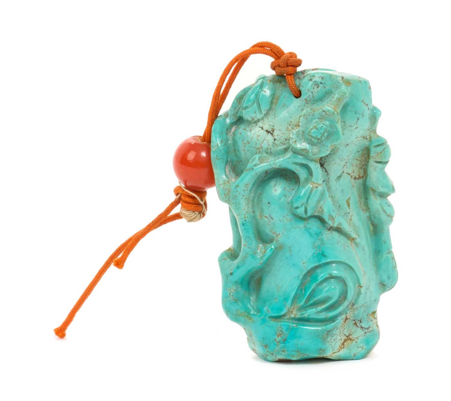 Lot 31 - Formerly the property of William Tallon R.V.M., Antique Chinese carved bluestone pendant of naturalistic trunk form with floral and leaf decoration on silk cord suspension 5.5 x 3cm Sold by thes...