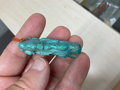 Lot 31 - Formerly the property of William Tallon R.V.M., Antique Chinese carved bluestone pendant of naturalistic trunk form with floral and leaf decoration on silk cord suspension 5.5 x 3cm Sold by thes...