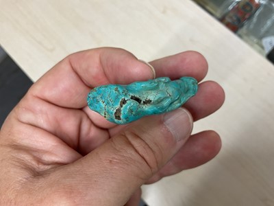 Lot 31 - Formerly the property of William Tallon R.V.M., Antique Chinese carved bluestone pendant of naturalistic trunk form with floral and leaf decoration on silk cord suspension 5.5 x 3cm Sold by thes...