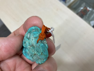 Lot 31 - Formerly the property of William Tallon R.V.M., Antique Chinese carved bluestone pendant of naturalistic trunk form with floral and leaf decoration on silk cord suspension 5.5 x 3cm Sold by thes...