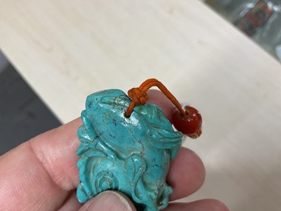 Lot 31 - Formerly the property of William Tallon R.V.M., Antique Chinese carved bluestone pendant of naturalistic trunk form with floral and leaf decoration on silk cord suspension 5.5 x 3cm Sold by thes...