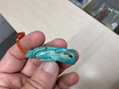 Lot 31 - Formerly the property of William Tallon R.V.M., Antique Chinese carved bluestone pendant of naturalistic trunk form with floral and leaf decoration on silk cord suspension 5.5 x 3cm Sold by thes...