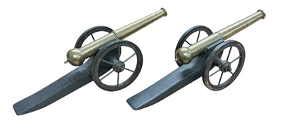 Lot 748 - Pair of early 20th century decorative brass cannons on wooden gun carriages, each 32cm in overall length.