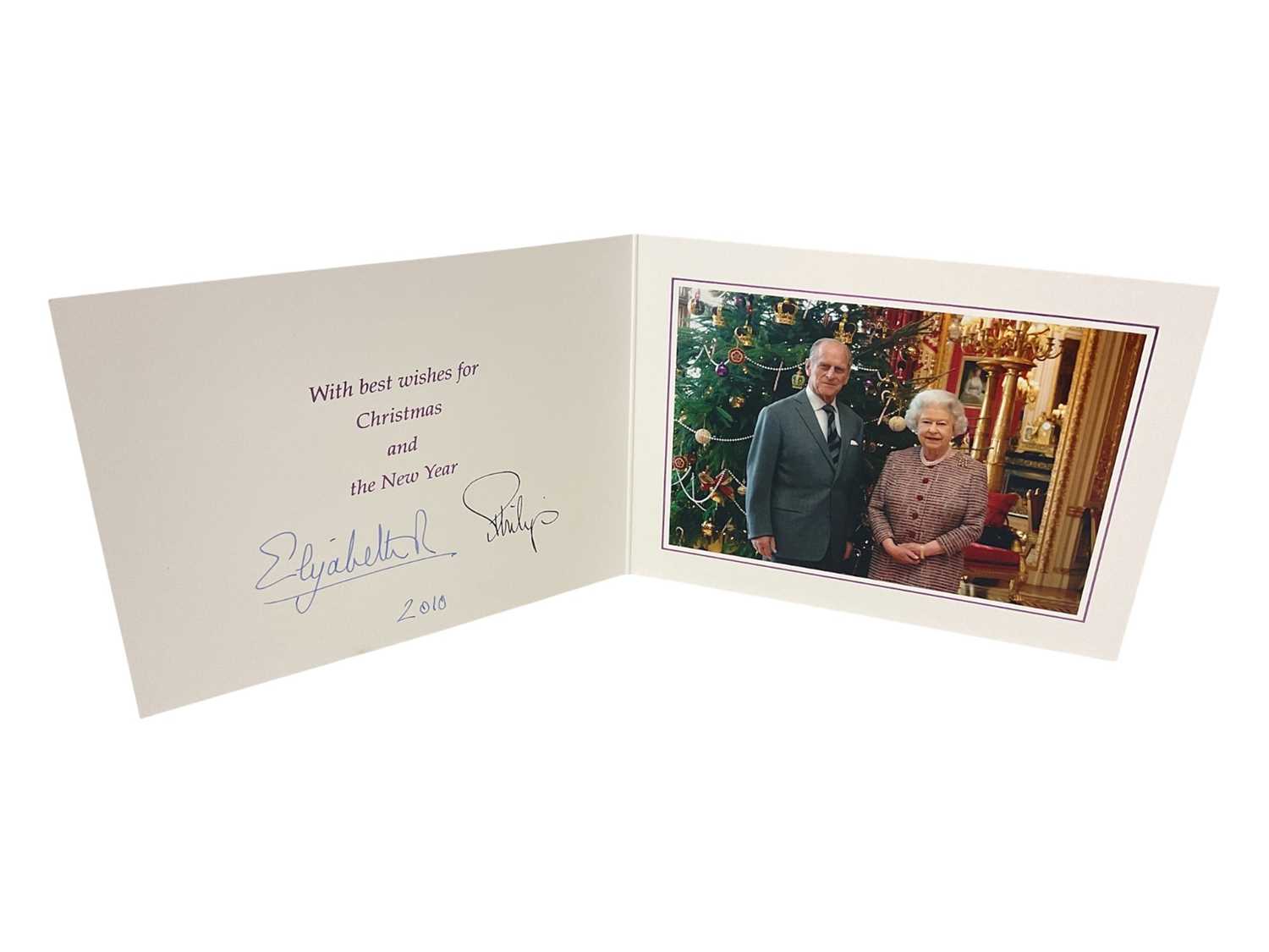 Lot 43 - H.M. Queen Elizabeth II and H.R.H. The Duke of Edinburgh signed 2010 Christmas card with twin gilt cyphers to cover, colour photograph of the smiling Royal couple next to a Christmas tree to the...