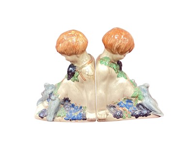 Lot 2326 - Percy Metcalfe for Ashtead Pottery, a pair bookends in the form of a boy with pigeons, printed marks to base.